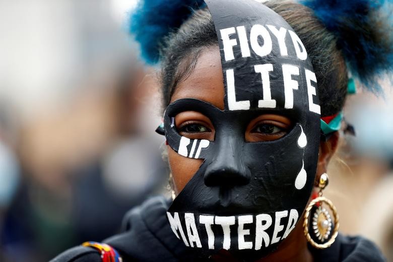 A woman wears a mask during a Black Lives Matter protest in Centenary Square in Birmingham, Britain. REUTERS/Jason Cairnduff    